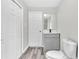 This is a bathroom with gray flooring, a gray vanity, and a standard white toilet at 164 Polar Rock Sw Dr, Atlanta, GA 30315