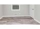 An empty bedroom featuring wood-look flooring, light gray walls, and trim at 164 Polar Rock Sw Dr, Atlanta, GA 30315