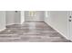 Neutral-toned bedroom showcasing gray vinyl plank flooring, ample natural light, and a white door at 164 Polar Rock Sw Dr, Atlanta, GA 30315