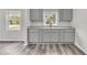 Bright kitchen featuring sleek gray cabinets, granite countertops, stainless sink and modern gray vinyl plank floors at 164 Polar Rock Sw Dr, Atlanta, GA 30315