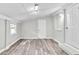 The cozy living room features updated gray vinyl plank floors, a white door and natural light at 164 Polar Rock Sw Dr, Atlanta, GA 30315
