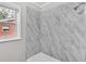 Newly tiled marble-look shower with tub and modern shower head at 164 Polar Rock Sw Dr, Atlanta, GA 30315