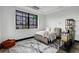 Cozy bedroom with large windows, comfortable bed, stylish rug, and storage shelves at 1805 Harvard Ave # 207, College Park, GA 30337