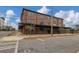 Three-story brick apartment building on a sunny day with sidewalk and trees at 1805 Harvard Ave # 207, College Park, GA 30337