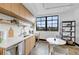 Open kitchen with modern cabinetry, sleek countertops, stainless steel appliances, and a large window at 1805 Harvard Ave # 207, College Park, GA 30337