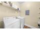 Bright laundry room featuring a white washer and dryer set and wire shelving for organized storage at 2103 Stratford Commons, Decatur, GA 30033