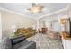 Bright living room with neutral walls, ceiling fan, plush couches, and an open floorplan with dining area at 2103 Stratford Commons, Decatur, GA 30033