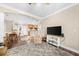 Open living and dining area with a cozy armchair, a dark wood floor, a flat screen TV and modern décor at 2103 Stratford Commons, Decatur, GA 30033