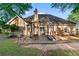 A lovely back exterior displaying a beautiful patio area with multiple seating options perfect for entertaining at 705 Branch Tree Way, Lawrenceville, GA 30043