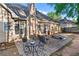 Charming backyard patio with brick pavers, patio furniture, and view of the house at 705 Branch Tree Way, Lawrenceville, GA 30043