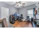 Bedroom featuring hardwood floors, a ceiling fan, and a large desk for work or hobbies at 705 Branch Tree Way, Lawrenceville, GA 30043