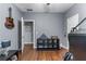 Bedroom featuring hardwood floors, neutral paint, and decorated shelving at 705 Branch Tree Way, Lawrenceville, GA 30043