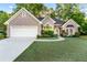 Charming home featuring well-manicured lawn, stone accents, and a two-car garage at 705 Branch Tree Way, Lawrenceville, GA 30043