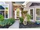 Close-up of the front door with stone accents and decorative landscaping at 705 Branch Tree Way, Lawrenceville, GA 30043