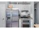 Updated kitchen features stainless steel refrigerator, gas range, and sleek, modern design at 705 Branch Tree Way, Lawrenceville, GA 30043