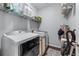 Functional laundry room with modern washer, dryer, and storage shelving for convenience at 705 Branch Tree Way, Lawrenceville, GA 30043