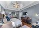 Spacious main bedroom with a tray ceiling, dark wood floors, and plenty of wall decor at 705 Branch Tree Way, Lawrenceville, GA 30043
