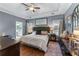 Main bedroom with tray ceilings, a plush headboard, and a view of the ensuite bathroom at 705 Branch Tree Way, Lawrenceville, GA 30043