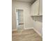 Functional laundry room with ample cabinet space and durable vinyl flooring at 1685 Crumbley Rd, Mcdonough, GA 30252