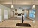 Open concept living room with a fireplace and built ins, visible from a kitchen with granite counters at 1685 Crumbley Rd, Mcdonough, GA 30252