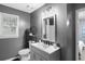 Bathroom featuring gray walls, a window and a vanity with modern fixtures and a framed mirror at 3568 Foxworth Ct, Buford, GA 30519