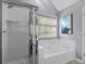 Clean bathroom featuring a glass-enclosed shower and a relaxing soaking tub at 3568 Foxworth Ct, Buford, GA 30519