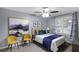 Cozy bedroom features a queen bed, window with curtains, and modern artwork at 3568 Foxworth Ct, Buford, GA 30519