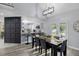 Open-concept dining area leading into the kitchen with modern chairs, a large table, and stylish lighting at 3568 Foxworth Ct, Buford, GA 30519
