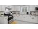 Beautiful kitchen featuring white cabinets, granite countertops, and stainless-steel appliances at 3568 Foxworth Ct, Buford, GA 30519