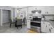 Eat-in kitchen has stainless steel appliances, light countertops, and gray dining set at 3568 Foxworth Ct, Buford, GA 30519
