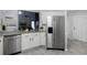 Modern kitchen showcases stainless steel refrigerator, gray countertops and tile flooring at 3568 Foxworth Ct, Buford, GA 30519