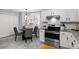 Eat-in kitchen has stainless steel appliances, light countertops, and gray dining set at 3568 Foxworth Ct, Buford, GA 30519