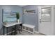 Office space boasts a white desk, decor and a white door with a bench and storage beneath decor shelf at 3568 Foxworth Ct, Buford, GA 30519