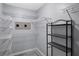 Walk-in closet with installed shelving and space for a full wardrobe at 3568 Foxworth Ct, Buford, GA 30519