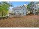 View of the backyard with a large deck and beautiful greenery around the home at 401 Briardale Court, Woodstock, GA 30189