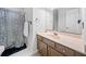 Bathroom with a shower, toilet, a cabinet with drawers, and a large mirror with a sink at 401 Briardale Court, Woodstock, GA 30189