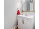 Well-lit half bath features a neutral color scheme and a decorative mirror at 401 Briardale Court, Woodstock, GA 30189