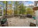 Spacious wooden deck with outdoor furniture surrounded by lush trees at 401 Briardale Court, Woodstock, GA 30189