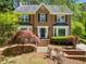 Charming two-story brick home with a manicured front yard and mature landscaping at 401 Briardale Court, Woodstock, GA 30189