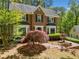 Traditional brick home with a manicured front yard and mature trees at 401 Briardale Court, Woodstock, GA 30189