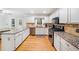 Open concept kitchen features stainless steel appliances, granite countertops, and eat in breakfast nook at 401 Briardale Court, Woodstock, GA 30189