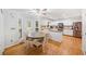 Well-equipped kitchen with white cabinets, stainless steel appliances, and a cozy dining area at 401 Briardale Court, Woodstock, GA 30189