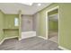 Well-lit bathroom with gray flooring, a shower, and green walls at 4653 Anns Se Trce, Acworth, GA 30102