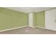 Well-lit bedroom features neutral carpet, green walls, and exterior access at 4653 Anns Se Trce, Acworth, GA 30102