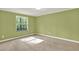 Bright bedroom features neutral carpet, green walls, and a large window at 4653 Anns Se Trce, Acworth, GA 30102