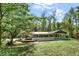 Charming single-story home with a large yard, mature trees, and inviting front porch at 4653 Anns Se Trce, Acworth, GA 30102
