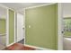 Hallway has an open doorway leading to another room with green walls and doors on either side at 4653 Anns Se Trce, Acworth, GA 30102