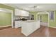 Kitchen features an island with white cabinets, stainless steel appliances, and tile backsplash at 4653 Anns Se Trce, Acworth, GA 30102