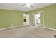Expansive living area with neutral carpet, green walls, and multiple doorways at 4653 Anns Se Trce, Acworth, GA 30102
