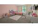 Cozy bedroom with desk, bed, tv, and a unique circular rug at 536 Crestridge Ct, Stone Mountain, GA 30083